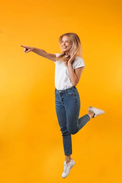 Full Length Portrait Satisfied Young Blonde Girl Pointing Away While — Stock Photo, Image