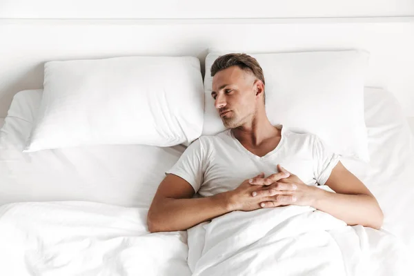 Hombre Trastornado Acostado Cama Mirando Una Almohada Vacía —  Fotos de Stock