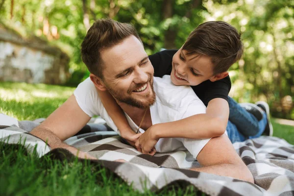 陽気な若い父親の写真は 公園の自然の屋外彼の幼い息子と楽しい時を過す — ストック写真