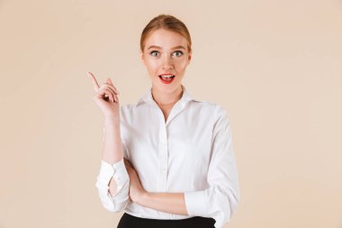 Sürpriz heyecanlı inanılmaz genç iş kadını izole kamera işaret arıyorum bej duvar artalan üzerinde duran görüntüsünü.