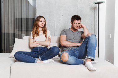 Fotoğraf seven çift evde kanepede kapalı kavga oturan rahatsız memnun genç.