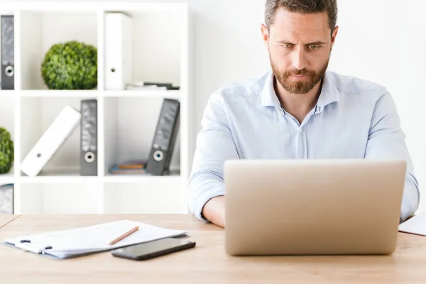 Homem Negócios Concentrado Trabalhando Computador Portátil Enquanto Sentado Mesa Escritório — Fotografia de Stock