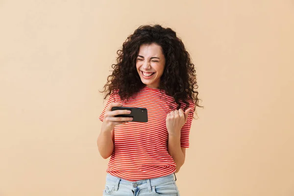 Image Emotional Excited Young Curly Woman Play Games Mobile Phone — Stock Photo, Image