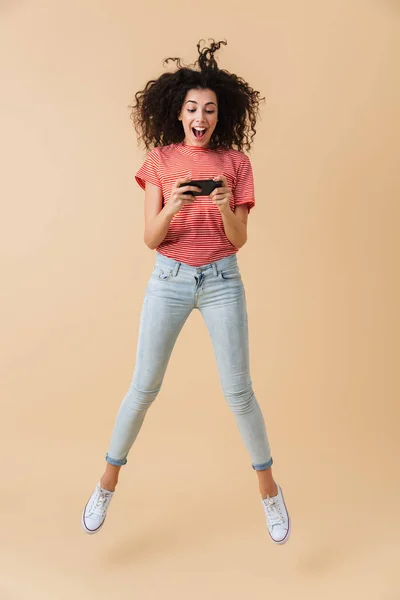 Full Length Portrait Cheerful Young Girl Playing Games Mobile Phone — Stock Photo, Image