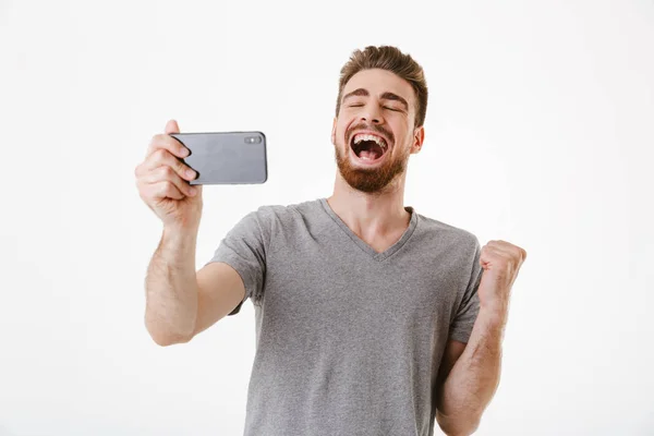 Imagen Joven Emocionado Pie Aislado Sobre Pared Blanca Juego Fondo — Foto de Stock