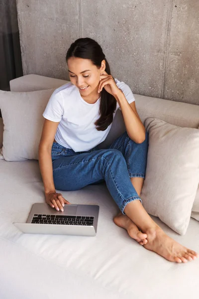 Freudige Junge Asiatische Frau Mit Laptop Computer Während Sie Hause — Stockfoto