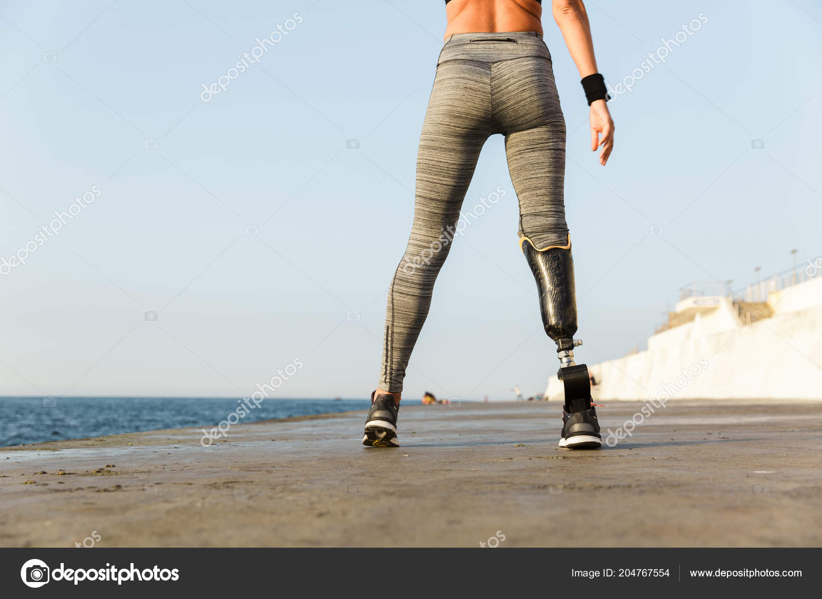 Cropped image of young disabled woman with prosthetic leg Stock