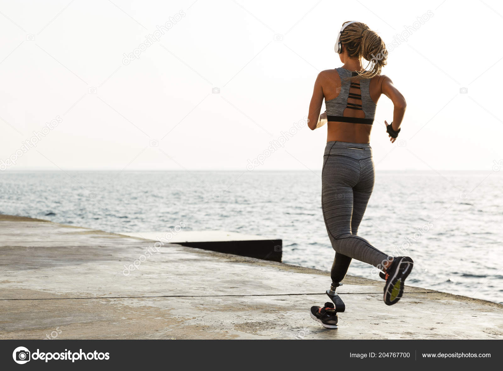 Attractive disabled athlete woman with prosthetic leg Stock Photo by  vadymvdrobot