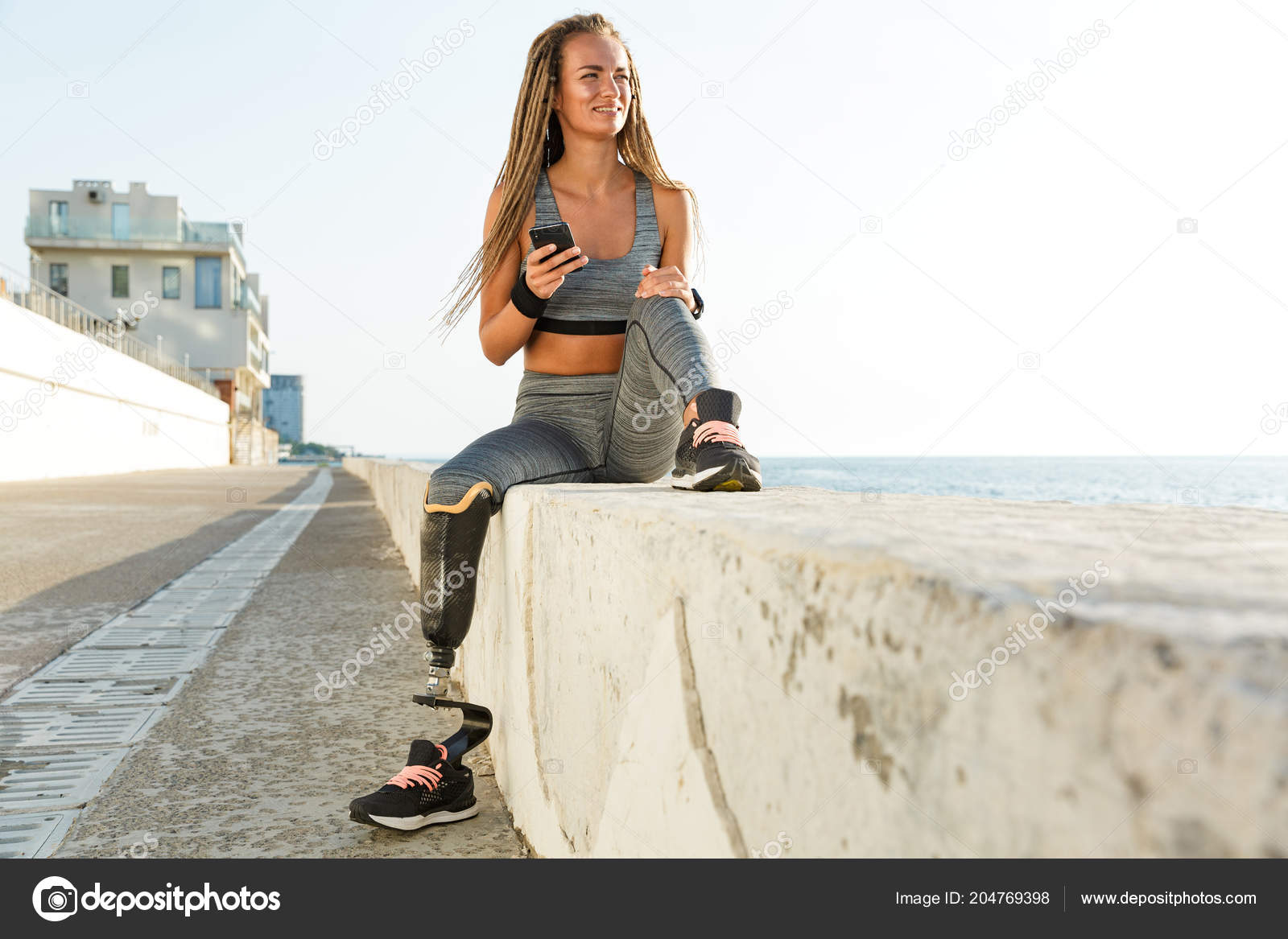 Cropped image of young disabled woman with prosthetic leg Stock