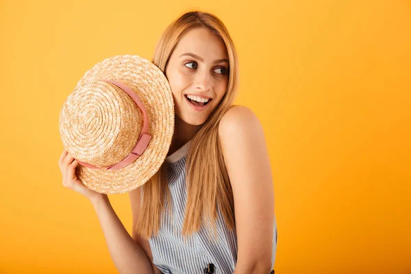 黄色の背景に分離された夏帽子でポーズ笑顔若いブロンドの女性の肖像画 — ストック写真