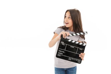 Klaket yapım film holding beyaz duvar arka plan üzerinde izole şirin kız ayakta görüntüsünü.