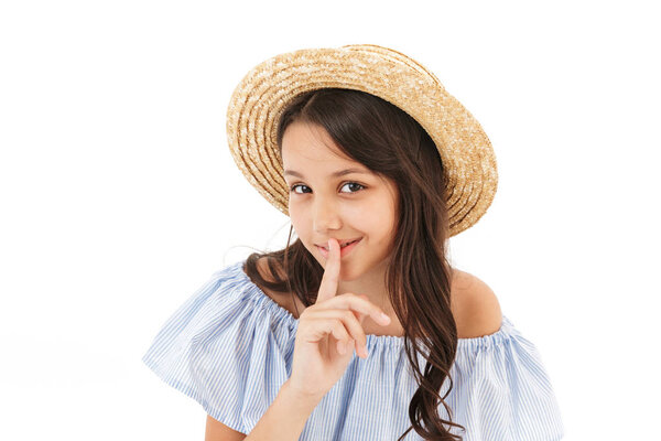 Image of cute girl standing isolated over white wall background make silence gesture.