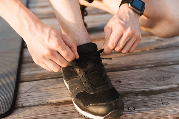 Close Man Tying His Shoelaces Wooden Ground — Stock Photo, Image