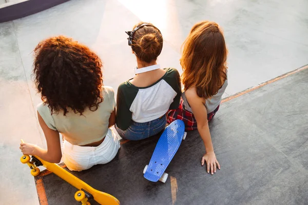 Vista Trasera Tres Chicas Jóvenes Bonitas Sentadas Con Monopatines Parque — Foto de Stock