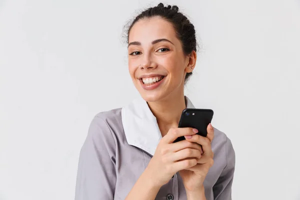 Portrait Smiling Young Housemaid Dressed Uniform Holding Mobile Phone Isolated — Stock Photo, Image
