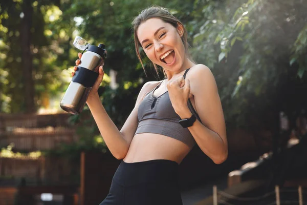 Portrait Happy Young Fitness Girl Holding Water Bottle Celebrating Success — Stock Photo, Image