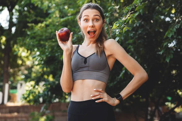 Portrait Excited Young Fitness Girl Showing Apple Outdoors — Stock Photo, Image