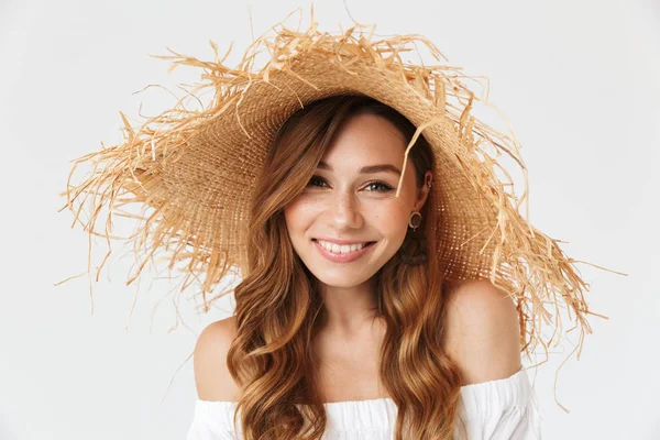 Portrait closeup of attractive charming woman 20s wearing big straw hat posing on camera with lovely smile isolated over white background