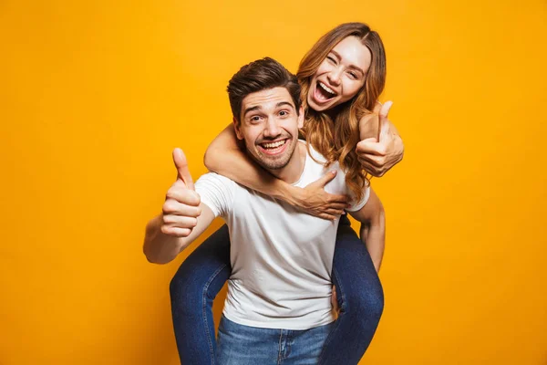 Image Joyous Couple Showing Thumbs While Man Piggybacking Joyful Woman — Stock Photo, Image