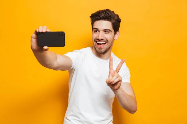 Portrait Cheerful Young Man Taking Sefie Mobile Phone Isolated Yellow — Stock Photo, Image