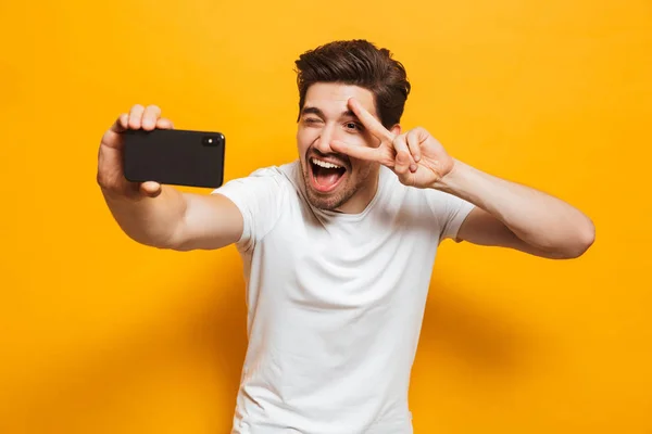 Portrait Cheerful Young Man Taking Sefie Mobile Phone Isolated Yellow — Stock Photo, Image