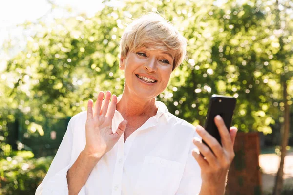 Wanita Dewasa Yang Bahagia Memiliki Video Chat Melalui Ponsel Saat — Stok Foto