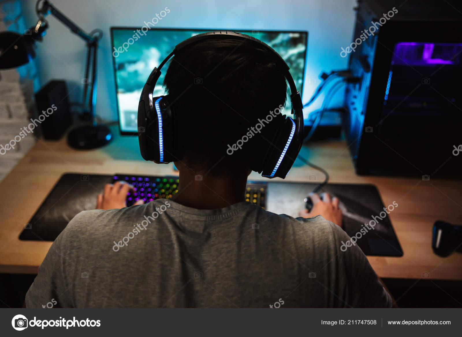 Teenager Boy Online Plays A Computer Game With Headphones And A