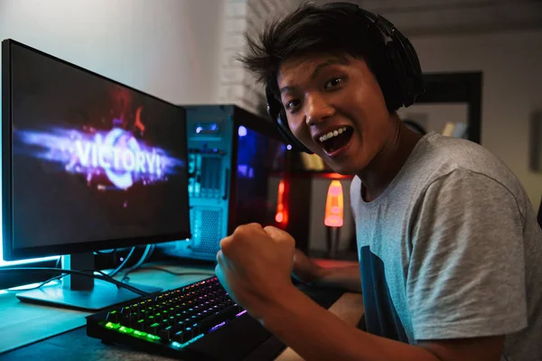 Ecstatic Asian Gamer Boy Rejoicing Victory While Playing Video Games — Stock Photo, Image