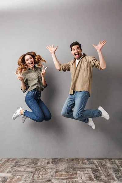 Retrato Larga Duración Una Alegre Pareja Joven Saltando Juntos Celebrando — Foto de Stock