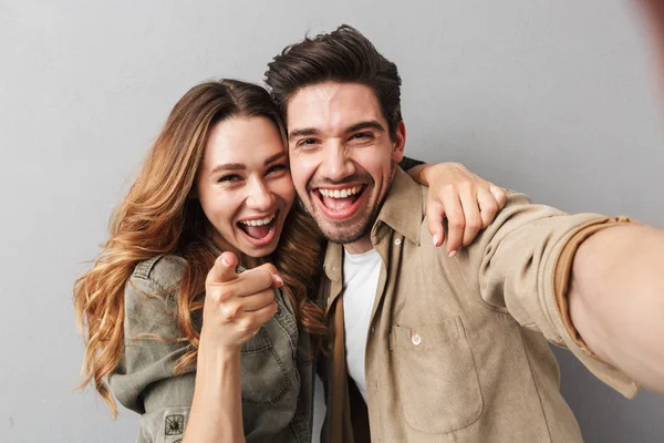 Portrait Happy Young Couple Hugging While Taking Selfie Pointing Finger — Stock Photo, Image