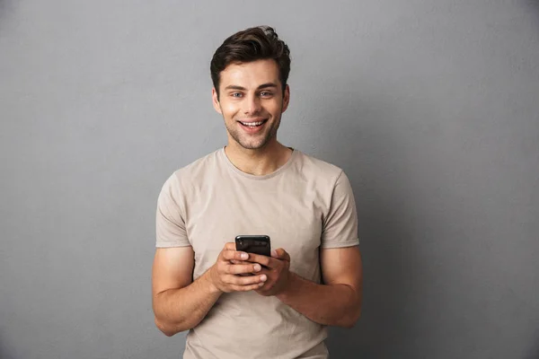 Happy Young Man Short Dark Hair Holding Smartphone Chatting Isolated — Stock Photo, Image