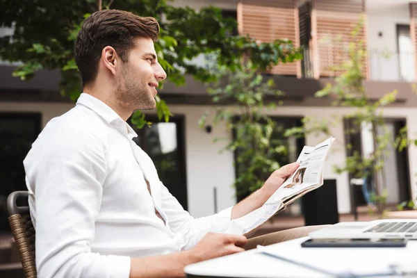 Attractive Young Businessman Dressed Shirt Sitting Cafe Outdoors Reading Newspaper — Stock Photo, Image