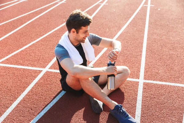 Deportista Agotado Terminó Corriendo Estadio Descansando Sosteniendo Botella Agua Mirando —  Fotos de Stock