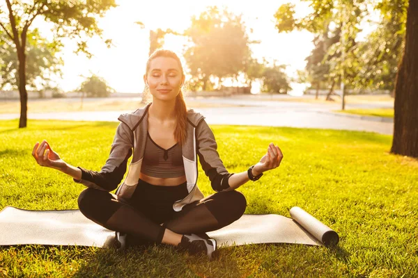 Foto Unga Fitness Kvinna 20S Sportkläder Mediterar Och Sitter Träningsmatta — Stockfoto