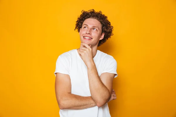 Portrait Smiling Pensive Curly Haired Man Looking Away Isolated Yellow — Stock Photo, Image