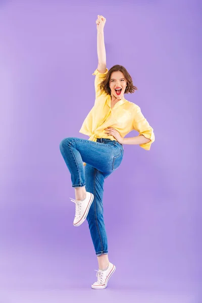 全长肖像的一个快乐的年轻女子身着夏季服装庆祝成功的紫罗兰背景 — 图库照片