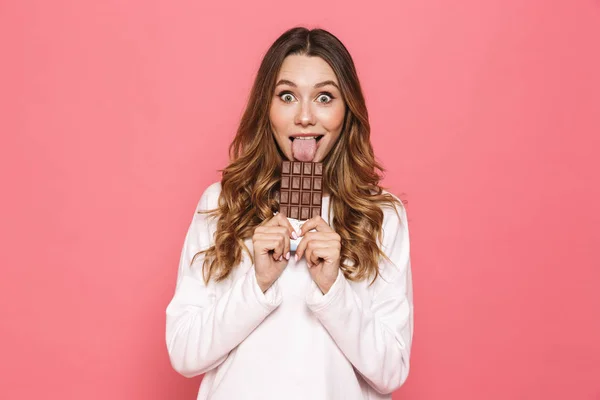 Portrait Happy Young Woman Licking Chocolate Bar Isolated Pink Background — Stock Photo, Image