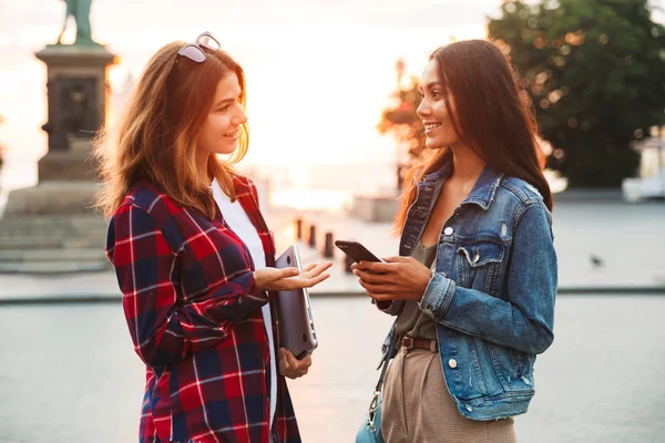Dva Usmívající Mladé Dívky Přátelé Stáli Ulici Města Notebook Mobilní — Stock fotografie