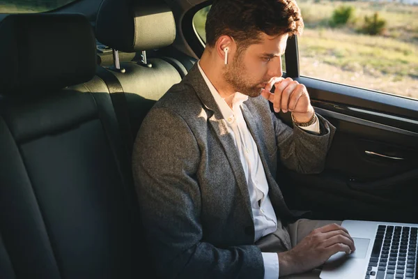 Fotografie Úspěšného Muže Nosit Oblek Bluetooth Sluchátka Pracují Notebooku Tak — Stock fotografie