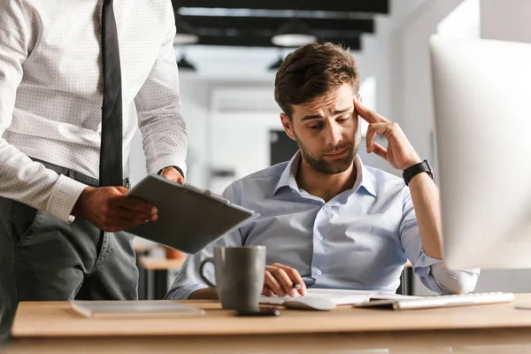 Picture Tired Displeased Man Sitting Office Working Computer His Colleague — Stock Photo, Image