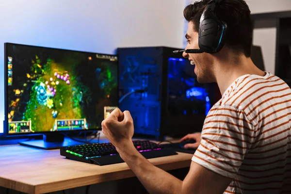 Portrait Delighted Young Guy Playing Video Games Computer Wearing Headphones — Stock Photo, Image