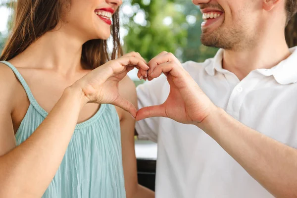 Cropped Image Young Cute Loving Couple Sitting Outdoors While Showing — Stock Photo, Image