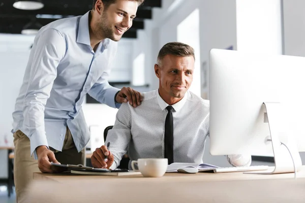 Image Smiling Two Colleagues Working Together Computer While Being Office — Stock Photo, Image