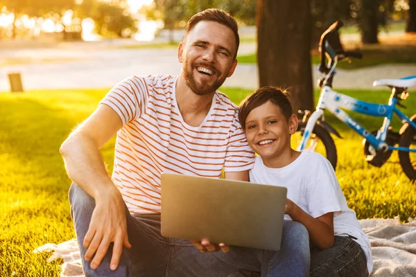 Pai Encantado Seu Filho Divertindo Juntos Parque Verde Usando Computador — Fotografia de Stock