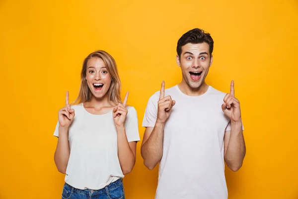 Happy Young Couple Pointing Fingers Isolated Background — Stock Photo, Image