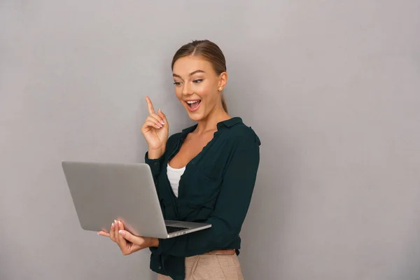 Glückliche Junge Geschäftsfrau Die Vor Grauem Hintergrund Steht Laptop Arbeitet — Stockfoto