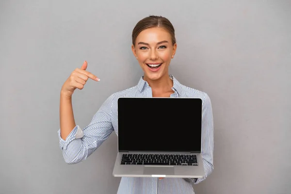 Feliz Joven Empresaria Pie Sobre Fondo Gris Mostrando Computadora Portátil — Foto de Stock