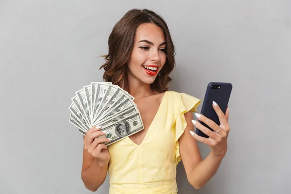 Portrait Smiling Young Girl Dress Standing Gray Background Holding Mobile — Stock Photo, Image