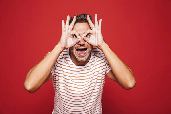 Funny Man Striped Shirt Smiling Looking Holes Made Fingers Isolated — Stock Photo, Image