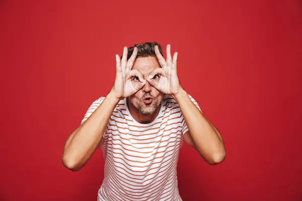 Caucasian Man Striped Shirt Smiling Looking Holes Made Fingers Isolated — Stock Photo, Image